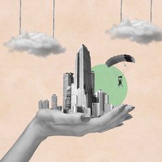 a person holding out their hand with a city in the sky and clouds above them