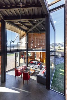 an open living room and dining area with glass walls