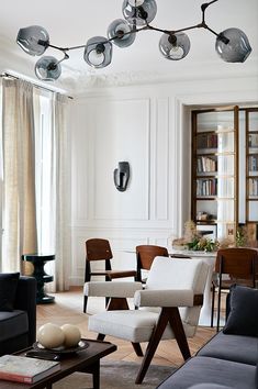 a living room filled with furniture and lots of windows