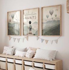 three pictures hang on the wall above a bench with storage bins and baskets underneath