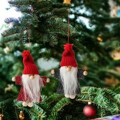 two gnome ornaments hanging from a christmas tree