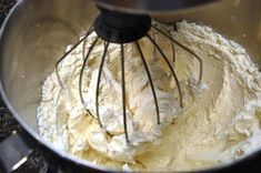 a metal bowl filled with batter on top of a counter