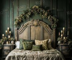 a bed that has some pillows on it and candles in front of the headboard