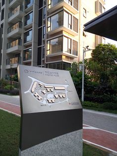 a sign is shown in front of a large building with balconies on it