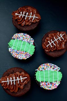 four decorated cookies with green frosting and footballs on them, one is chocolate