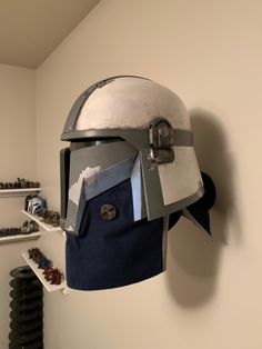 a helmet that has been made to look like a knight's helmet is hanging on the wall