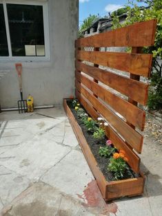 a wooden bench sitting on top of a patio next to a flower potted planter