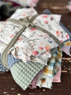 a stack of cloths sitting on top of a wooden table