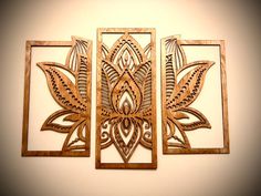 three wooden wall art pieces hanging on the wall