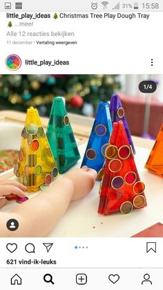 an image of a child playing with colored plastic christmas trees