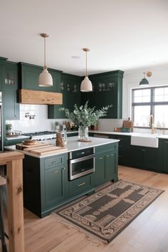 a kitchen with dark green cabinets and white counter tops, an area rug on the floor