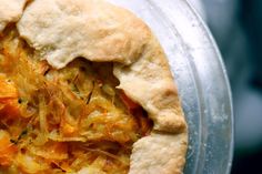 there is a pie that has been cut in half and topped with orange zest