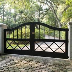 a driveway gate with brick walkway leading to it