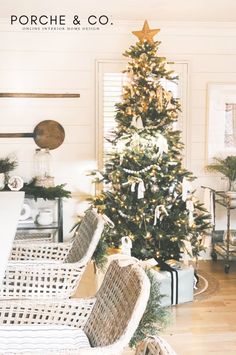 a living room with a christmas tree and wicker chairs