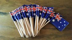 several australian flags are placed on top of each other with toothpicks in them