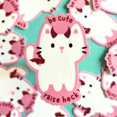 a bunch of pink and white stickers with cats on them that say be cute