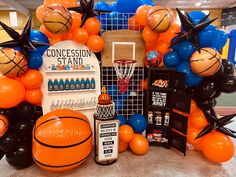 an assortment of basketballs and balloons on display at a sports themed birthday party or celebration