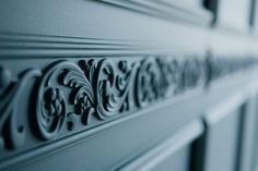 close up view of an ornate design on the side of a building's door