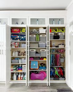 an organized closet with lots of items and storage bins on the bottom shelf in front of it