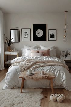 a bed with white sheets and pillows in a bedroom next to a window filled with pictures