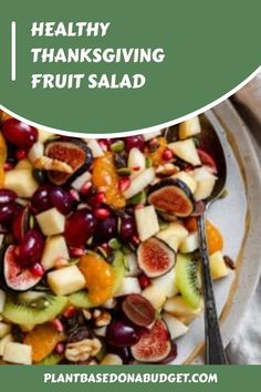 a white plate topped with fruit salad on top of a table