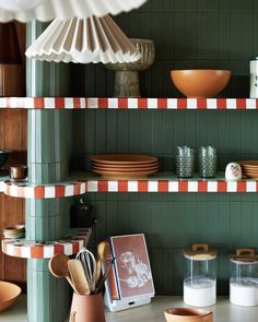 the shelves in this kitchen are filled with dishes and utensils