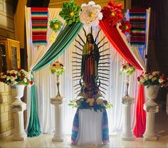 an altar decorated with flowers and cloths