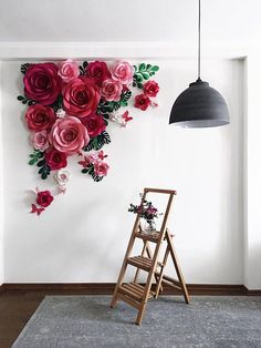 a room with a ladder and flowers on the wall