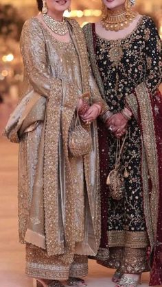 two women standing next to each other in wedding outfits