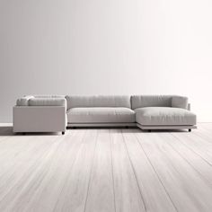 a white couch sitting on top of a wooden floor