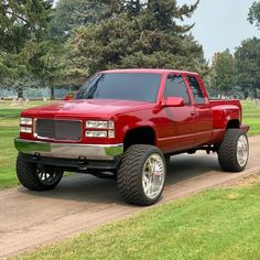 a red pick up truck parked on the side of a road