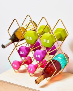 the wine rack is filled with different colored bottles