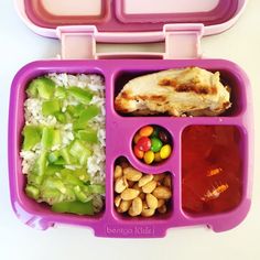 a purple lunch box filled with lots of food