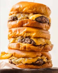 cheeseburger stacked on top of each other with fries