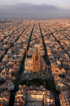 an aerial view of barcelona, spain with the cathedrals in the foreground and other buildings