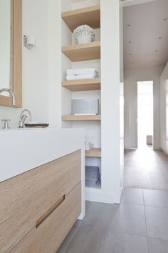 the bathroom is clean and ready to be used as a storage area for towels or other items