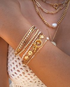 Channel your inner greek goddess with our shiny coin bracelet. Easy to dress up or down, pair this piece with a flowy white dress and strappy sandals, or with a white button up and blue jeans for a casual look. This beauty pairs well with any simple gold layering chains or bead bracelets. 14k Gold Vermeil Hypoallergenic Dimensions: 6" + 1" extender (7" total) Jewelry Stacking Ideas, Stackable Gold Bracelets, Golden Bracelet Stack, Cool Tone Jewelry, Bracelet Stack Inspo Gold, Bracket Stack Ideas, Gold Bracelet Stack Aesthetic, Swarovski Jewelry Gold, Gold Bracelet With Pearls