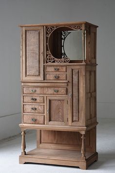 an old wooden cabinet with mirror on top