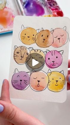 a person holding up a card with cats on it