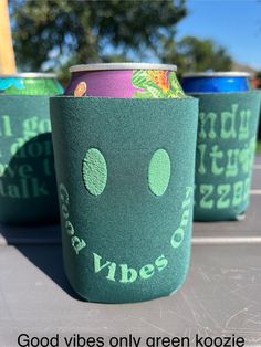 three green cups with the words good vibes on them are sitting in a row