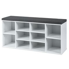 a white shelf with several compartments and a black top