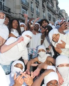 a group of people with white heads covering their faces