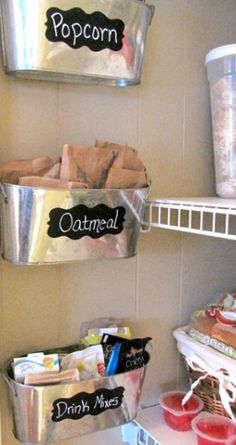 two metal containers filled with food on top of a shelf