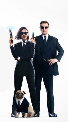 man and woman dressed in business attire holding cell phones next to a pug dog