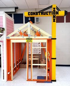 an orange and yellow building with a sign that says construction zone