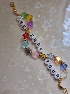 a bracelet with charms that say happy new year and star shaped beads on the clasp