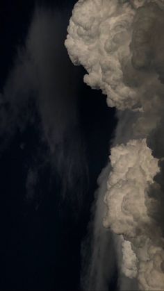 an airplane is flying in the sky with clouds