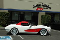 a white and red car parked in front of a building