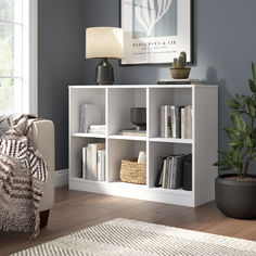 a living room with a couch, chair and bookshelf