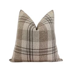 a brown and white plaid pillow on a white background